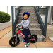 Strider™ Sport Balance Bicycles  - Kid straddling bike